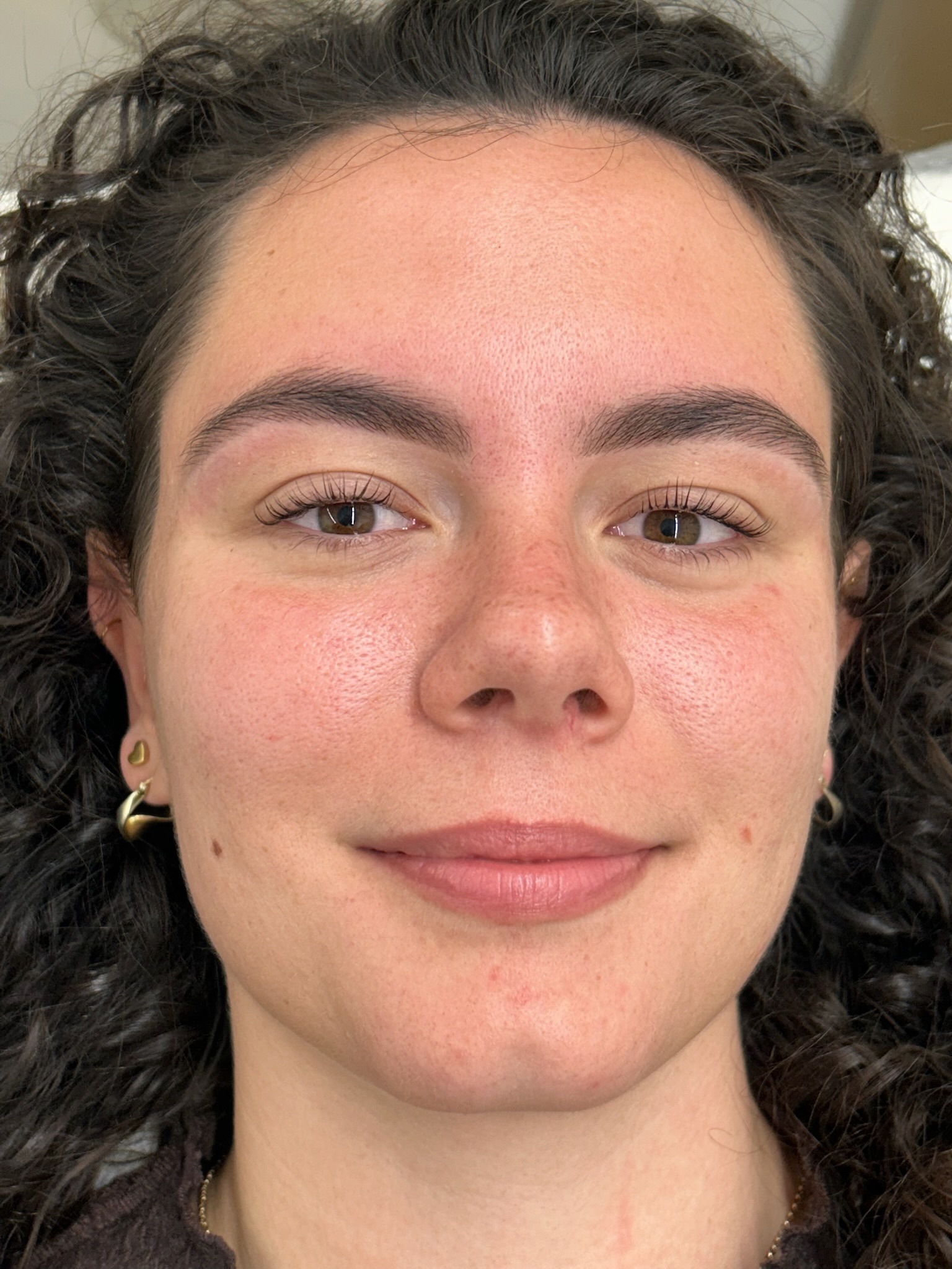 Client with tinted and shaped brows showing natural definition