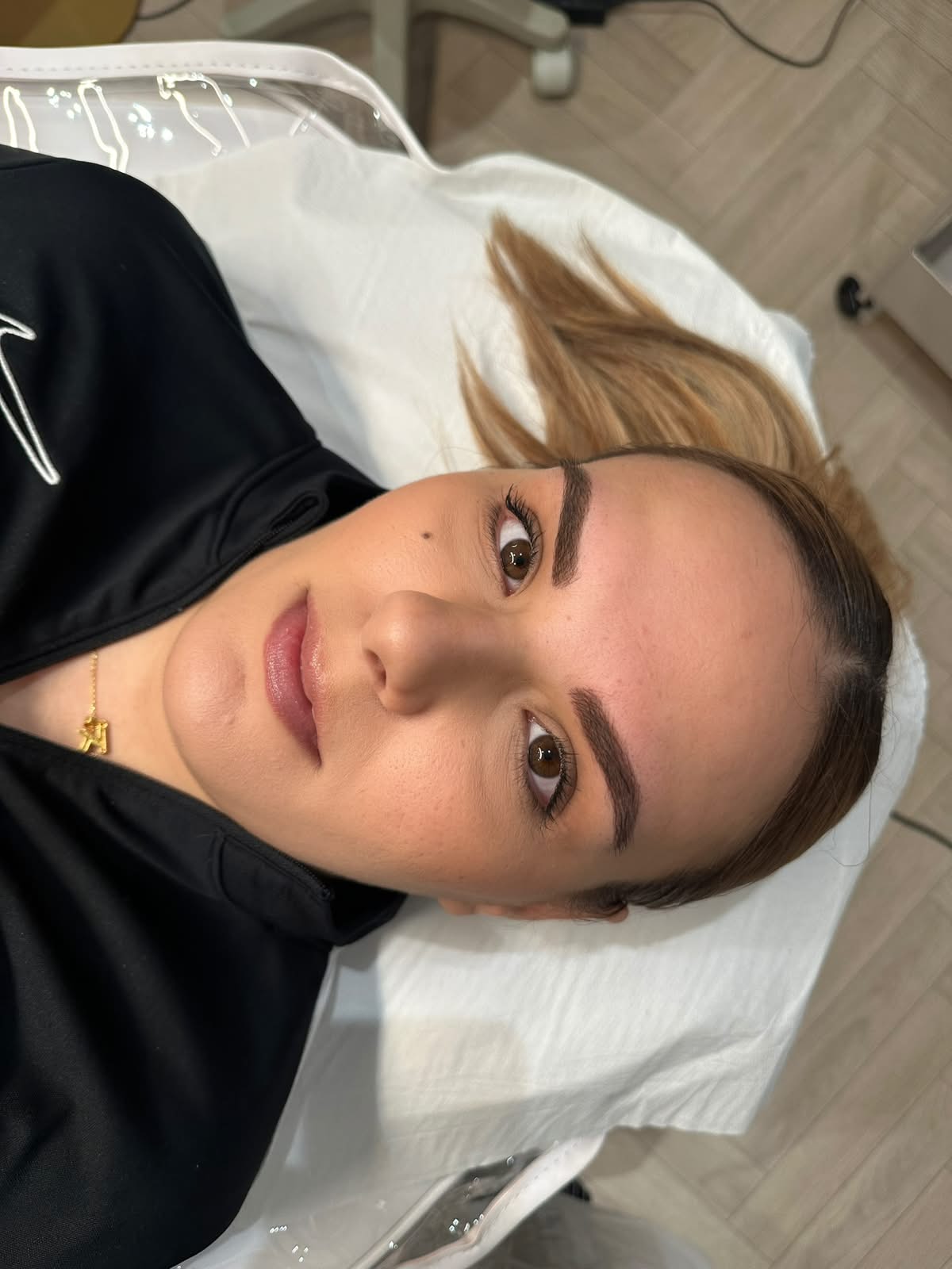 Close-up portrait of a client after ombré brow treatment with softly shaded, sculpted brows