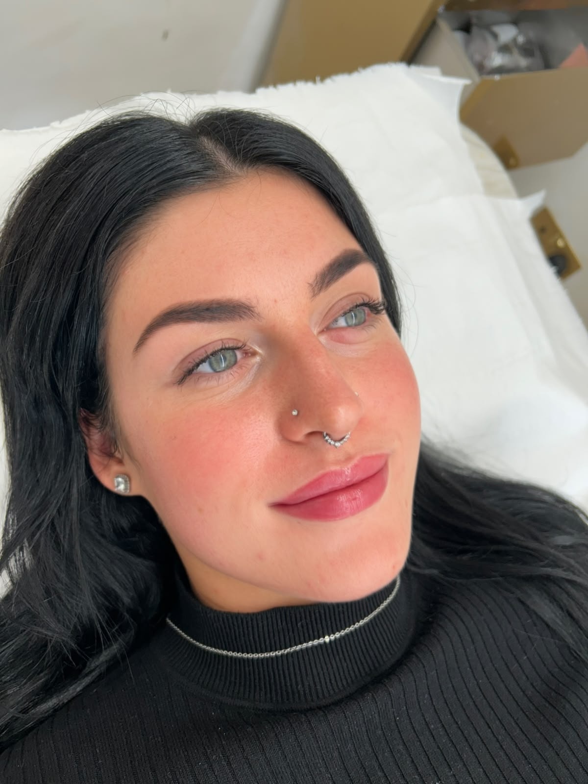 Client portrait after lip blush treatment showing glossy, naturally tinted lips with soft pink definition
